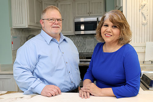 Long-term care administrator program faculty member and student standing in an assisted living facility kitchen