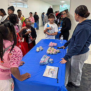 Children interacting with STEM activity at STEAMagination event booth